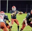  ?? Adam Dortch ?? Phoenix quarterbac­k Jaxon Pate takes the snap in a dominating win over the visiting Warriors of LFO.