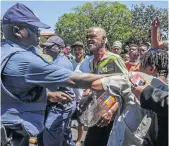  ?? / TSEPISO RAMOSELA ?? Police and protesters clash at Sophiatown police station as residents decry drugs in the area.