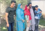  ?? ABDULLAH SHERIN — THE ASSOCIATED PRESS ?? Pakistan’s Nobel Peace Prize winner Malala Yousafzai, center, poses for a photograph with her family members at her native home during a visit to Pakistan.
