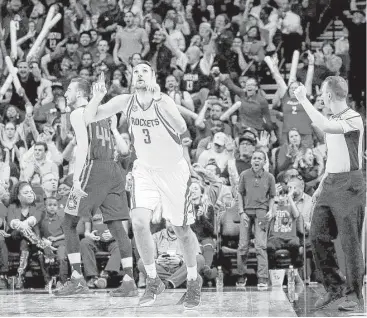  ?? Jon Shapley / Houston Chronicle ?? True to his uniform number, Rockets forward Ryan Anderson reacts after making the go-ahead 3-point shot off an assist by James Harden, who collected his 11th triple-double of the season Tuesday night.