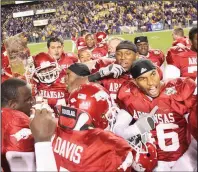  ??  ?? BELOW Arkansas players celebrate with the Golden Boot Trophy after defeating LSU in 2007. It was the Razorbacks’ first victory over a top-ranked team since beating No. 1 Texas in 1981. (Democrat-Gazette file photo)