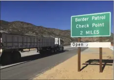  ??  ?? In this Dec. 14 photo, a sign warns of the upcoming Pine Valley checkpoint, on the main route from Arizona to San Diego. AP PHOTO/ELLIOT SPAGAT