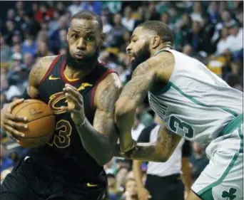  ?? MICHAEL DWYER — THE ASSOCIATED PRESS FILE ?? Cleveland’s LeBron James (23) drives against Boston forward Marcus Morris the third quarter of a game earlier this season. (13) during