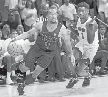  ?? LM Otero Associated Press ?? USC GUARD Jordan McLaughlin drives past SMU guard Shake Milton during the first half in Dallas. Milton scored 22 points for the Mustangs, who improved to 31-0 at home under coach Tim Jankovich.