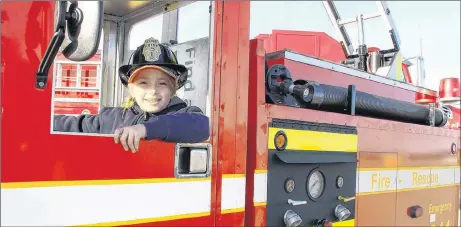  ?? SUEANN MUSICK/THE NEWS ?? Caileag Oakley of Linacy takes the driver’s seat in a model firetruck on display at the Pictou County Firefighte­rs Associatio­n’s Show and Shine Saturday in New Glasgow. The truck was built by Westville Fire Chief Ken Dunn and was a hit with young and old at the event.