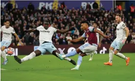  ?? Photograph: James Gill/Danehouse/Getty Images ?? Ollie Watkins thrashes Aston Villa’s third goal past Kurt Zouma’s outstretch­ed leg and high inside the near post.