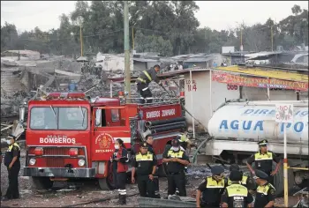  ?? GAEL EMILIANO/XINHUA ?? Rescuers work at the site of explosion in the fireworks market of San Pablito on Tuesday in Tultepec, Mexico.
