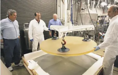  ?? Ben Margot / Associated Press 2008 ?? Thirty Meter Telescope project scientist Jerry Nelson (left) inspects parts with Brian Dupraw, Telescope Optics Group leader Eric Williams and Dave Hilyard at UC Santa Cruz’s Observator­y Optical Lab in 2008.