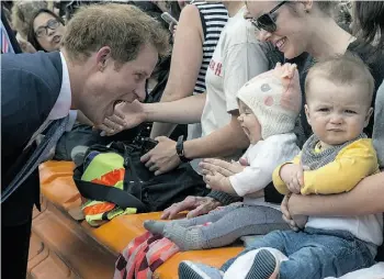  ?? Iain McGregor/AFP/Getty Images ?? Prince Harry mimics a baby yawning in Christchur­ch, New Zealand, Tuesday. The prince says he would love to have a family, but is not going to force romance to happen.