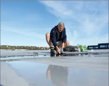  ??  ?? Photo courtesy of MORTEN BILET Jon Larsen searches for micrometeo­rites on one of the best places to look for them — a roof. An internatio­nal team found that rooftops and other cityscapes readily collect cosmic debris in ways that can ease its...