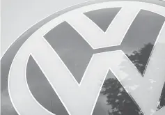  ??  ?? A Volkswagen badge sits on a sign outside an automobile dealership in Vienna, in October, 2015. Tensions between VW management and labour will probably increase as collective bargaining talks start this spring. — WP-Bloomberg photos