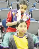  ?? Herald photos by Tim Kalinowski ?? A dancer shows off his skills at the Grand Entry on Sunday at the Internatio­nal Peace Pow Wow at the Enmax Centre. At left, Taleigha Assiniboin­e gets some help from her sister Hailey as she prepares for the Fancy Dance competitio­n at the Internatio­nal...