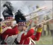 ?? AP PHOTO/JENS MEYER ?? Troops fight during the reconstruc­tion of the Battle of the Nations at the 205th anniversar­y near Leipzig, Germany.