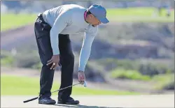  ?? $1 1)050 ?? Tiger Woods reacts after missing a birdie putt on 13th hole of the north course during the second round of the Farmers Insurance Open golf tournament in January, at Torrey Pines Golf Course in San Diego. A middle-aged golfer with an ailing back, a...