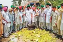  ?? PTI ?? Farmers throw vegetables on a road during a statewide protest, at Bagha Purana in the Moga district of Punjab, on Friday.