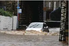  ??  ?? CALDERDALE: A car drives through flood waters at Mytholmroy­d in Calderdale, West Yorkshire, England yesterday. Parts of northwest England already hit hard by flooding in recent weeks were under severe flood warnings yesterday because of forecasts for...