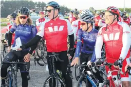 ?? PHOTO: KAREN PASCO ?? Sir John Kirwan (second from left) hands out the lollies at the second to last stop on the Westpac Chopper Ride to (from left) Black Spokes riders Dylan McCullogh and Aaron Gate, while 10time event cyclist and organiser Phil Taylor looks on.