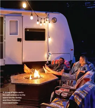  ??  ?? A string of lights and a fire add ambience to the space beside Ashley and Dino Petrone’s renovated trailer