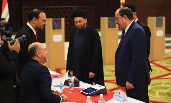 ?? Getty Images ?? Former Iraqi prime minister Nouri Al Maliki and head of the National State Forces Alliance Ammar Al Hakim vote at Al Rasheed Hotel in Baghdad’s Green Zone, during the country’s first elections for provincial councils in more than a decade