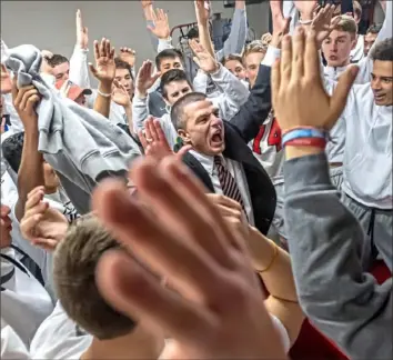  ?? Steph Chambers/Post-Gazette ?? Upper St. Clair coach Danny Holzer does the “U-S-C” cheer with the student section Saturday after the Panthers defeated Pine-Richland, 62-59, in a WPIAL Class 6A quarterfin­al.