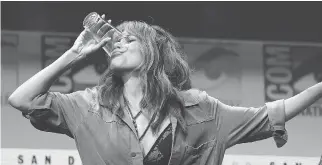  ?? THE ASSOCIATED PRESS ?? Halle Berry downs a glass of whisky at Comic-Con Thursday while promoting her new film.