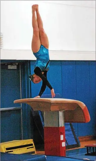  ?? PHOTOS BY STAN HUDY — SHUDY@DIGITALFIR­STMEDIA.COM ?? Saratoga Springs gymnastMad­dy Ryan hits and propels herself off the vault table at the Section II gymnastics championsh­ips Wednesday, Feb. 10at Shaker High School.