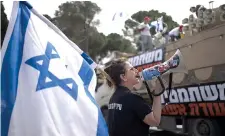  ?? ?? Members of Brothers and Sisters in Arms and Bonot Alternativ­a (Women Building an Alternativ­e) protest Tuesday about Israel’s exemptions for ultra-orthodox Jews from mandatory military service, near the prime minister’s office in Jerusalem. (AP photo/maya Alleruzzo)