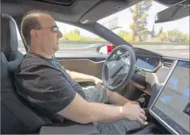  ?? Katie Falkenberg Los Angeles Times ?? TESLA HAS called Autopilot an “assist feature.” Above, Jason Fudenberg, president of the L.A. Tesla Club, drives using Autopilot near Sherman Oaks last year.