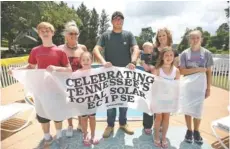  ?? STAFF PHOTOS BY ERIN O. SMITH ?? Hunter Esch, Jeanette Esch, Lila Higdon, Matthew Burkhart, Jaxon Roeser, Jeana Roeser, Aurora Esch and Gracie Roeser, from left, worked on several projects for their eclipse party at Jeanette’s house.