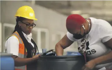  ?? ?? A Customs Officer inspects and examines an imported barrel at a Kingston port as a part of our Border Protection mandate. This activity is done only in the presence of the importer or his/her Agent.