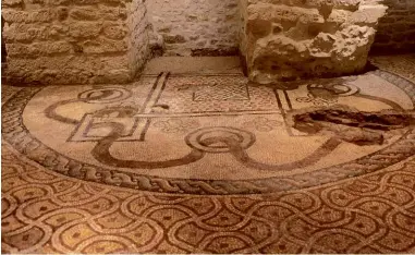  ??  ?? TOP LEFT: An Orthodox bishop celebrates mass at the tomb of Saint Nicholas. TOP RIGHT: One of the faithful touches the legendary ‘flying column’ of red porphyry in the crypt of the Basilica of Saint Nicholas. ABOVE: The unusual mosaic of a huge serpent found on the floor of the crypt in the Cathedral of San Sabino.