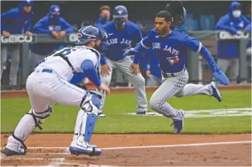  ?? — USA TODAY SPORTS ?? The Blue Jays' Josh Palacios heads for the plate past Royals catcher Cam Gallagher in Saturday's second game in Kansas City.