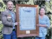  ?? PHOTO: SUPPLIED ?? Proud moment . . . Michael Crossley and his mother Tracy hold up an honours board commemorat­ing World War 1 and the Boer War on behalf of father and husband Chris Crossley, who organised for it to be handed over to the Winton RSA before his death.