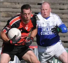  ??  ?? David Currid retains possession as Jim Bob Levingston­e moves in.