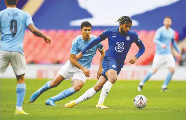  ?? — POOL/AFP VIA GETTY IMAGES ?? Chelsea defender Reece James vies with Manchester City midfielder Rodrigo during the English FA Cup semifinal match on Saturday at Wembley Stadium. Chelsea and Manchester City are two of the clubs threatenin­g to break away from the Champions League.