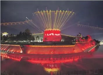  ?? Getty I mages ?? CHINA’S economy has slowed dramatical­ly under Xi, in part because the private sector has been spooked by his talk of communist revival. Above, a city wall is illuminate­d during a light show in Shaanxi province.