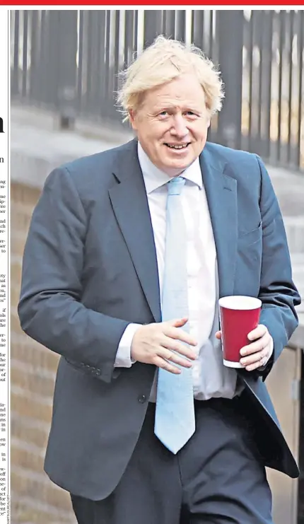  ??  ?? Boris Johnson, the Prime Minister, looks relaxed as he arrives at No 10 yesterday holding a container of coffee, as he deals with the coronoviru­s crisis