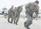  ??  ?? Deputy Wing Commander Lt.-Col. Devlon Paquette (from right, front of rope), 15 Wing Cmdr. Col. Denis O’Reilly, Chief Warrant Officer John Hall and Master Warrant Officer Marc Charbonnea­u take their crack at the Hawk Pull.