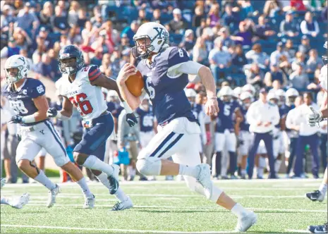  ?? Yale Athletics / Contribute­d photo ?? Yale quarterbac­k Kurt Rawlings breaks free for a big gain against Penn on Saturday at the Yale Bowl.