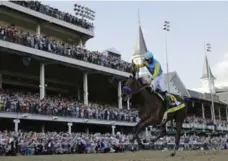  ?? DAVID J. PHILLIP/THE ASSOCIATED PRESS ?? Victor Espinoza rides American Pharoah to victory in the 141st Kentucky Derby, the start of a remarkable stretch for the three-year-old.