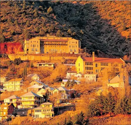  ?? Morey Milbradt Getty Images ?? NESTLED in the steep slopes of Shadow Hill, the Jerome Grand Hotel, which opened in the 1990s, overlooks the town of Jerome.