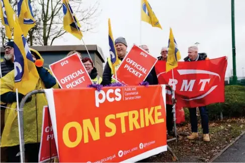  ?? (PA) ?? Striking border workers outside Birmingham airport l ast month
