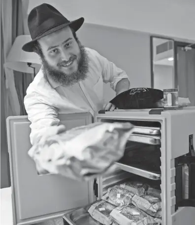  ?? AP ?? Rabbi Eli Chitrik makes freshly baked bagels in Qatar at a designated kitchen, set up to feed Jewish World Cup visitors who want to keep kosher during the tournament.