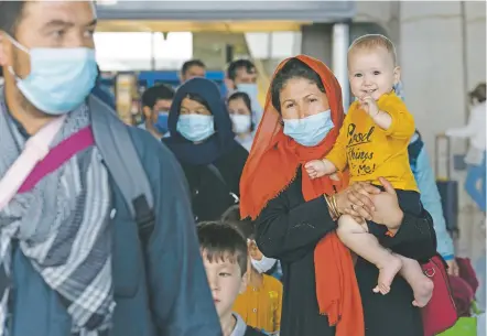  ?? JOSE LUIS MAGANA/ASSOCIATED PRESS ?? Families evacuated from Kabul, Afghanista­n, arrive at Washington Dulles Internatio­nal Airport on Tuesday in Chantilly, Va.