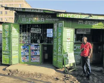  ?? Picture: REUTERS ?? PAYMENT CAFE: A man waits for M-Pesa customers at his shop in Kibera, in Kenya’s capital, Nairobi