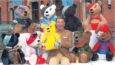  ?? Picture: PA. ?? “A twinkly-eyed common touch”. Sir Terry Wogan with a selection of Pudsey Bears, the symbol of his beloved Children in Need appeal.