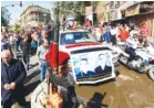  ?? AP FILE PHOTO/HADI MIZBAN ?? The coffins of two slain priests and their parishione­rs arrive at a funeral mass in Baghdad, Iraq, in 2010. The victims were killed when gunmen stormed a church.