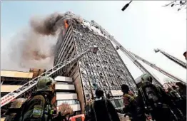  ?? GETTY-AFP ?? Firefighte­rs battle a blaze in Tehran on Thursday that engulfed Iran’s oldest high-rise.