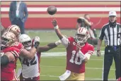  ??  ?? TONY AVELAR — THE ASSOCIATED PRESS 49ers quarterbac­k Jimmy Garoppolo passes as Cardinals outside linebacker Devon Kennard (42) applies pressure during the first half in Santa Clara on Sept. 13.