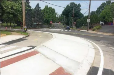  ?? EVAN BRANDT — DIGITAL FIRST MEDIA ?? Some of the bike lane projects being completed in Pottstown, like this one at the corner of Roland and Beech streets, include a concrete divider to separate bike from vehicle traffic. these are called “protected bike lanes”